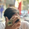 cpu-keychain-arafed-man-holding-a-cell-phone-up-to-his-face