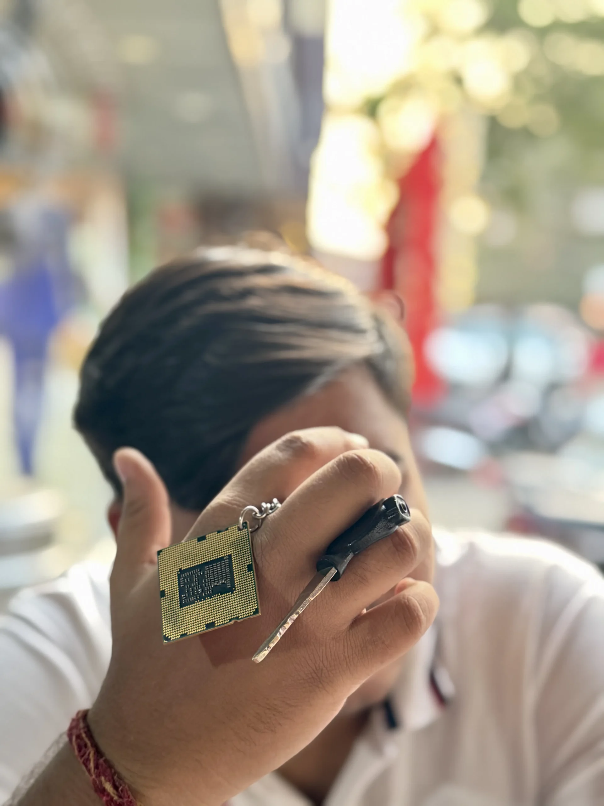 cpu-keychain-arafed-man-holding-a-cell-phone-up-to-his-face