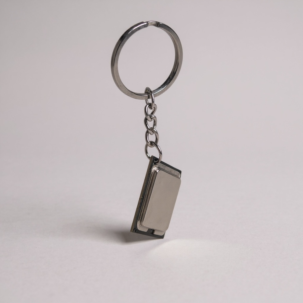 cpu-keychain-there-is-a-small-metal-keychain-with-a-book-on-it